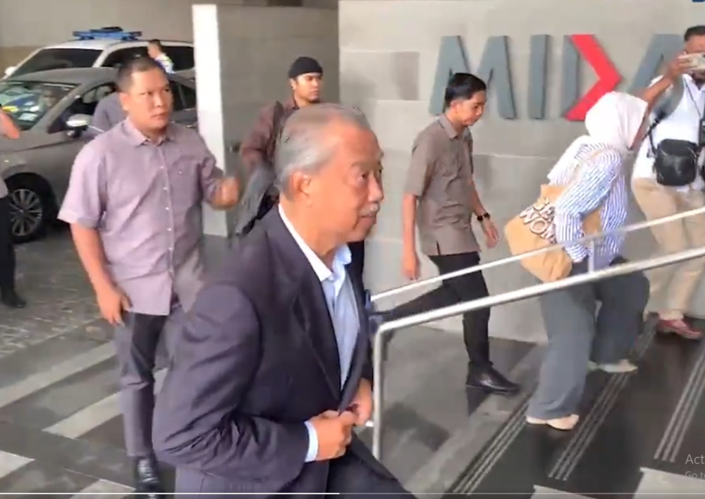 Perikatan Nasional (PN) chairman Tan Sri Muhyiddin Yassin arrives at the Malaysian Investment Development Authority (Mida) building this morning to give a statement. — Screengrab from social media 
