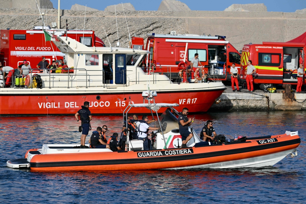 A rescue boat of the Italian Coast Guards operates in Porticello near Palermo, on August 20, 2024 a day after the British-flagged luxury yacht Bayesian sank. Specialist divers launched a fresh search for six people, including UK tech tycoon Mike Lynch and the chairman of Morgan Stanley International, missing since their yacht capsized off the Italian island of Sicily. — AFP pic