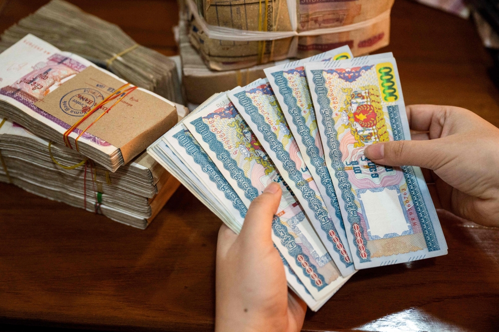 The Myanmar kyat has been extremely volatile in recent days, plunging to a low of 7,500 (RM10.1) to the dollar in the black market last week from 5,000 earlier in the month. — AFP pic