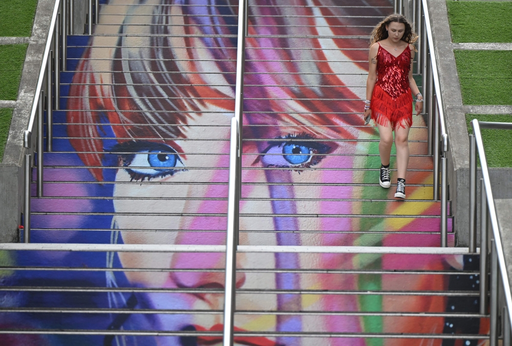 A fan of US mega-star Taylor Swift uses the ‘Swiftie Steps’ a mural created by the British artist Frank Styles, outside Wembley Stadium in London. — AFP pic