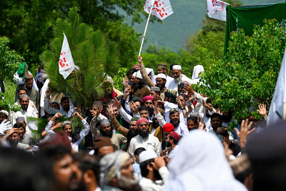 Supporters of Tehreek-e-Labbaik Pakistan (TLP) party gather near the capital's 