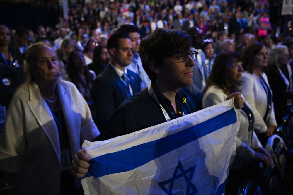 An attendee holds an Israeli flag on Day 3 of the Democratic National Convention (DNC) in Chicago, Illinois, U.S., August 21, 2024. — AFP pic