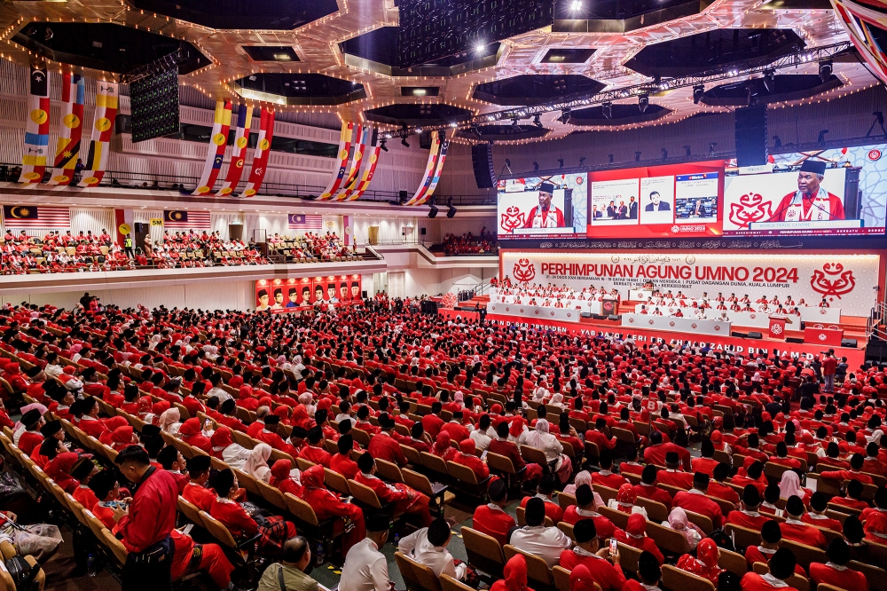 Umno president Datuk Seri Ahmad Zahid Hamidi’s opening speech at the 2024 Umno General Assembly is broadcast through several large screens inside the World Trade Centre Kuala Lumpur on August 23, 2024. — Picture by Firdaus Latif