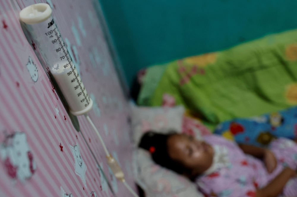 A feeding syringe fixed to the bedroom wall above Sheena Almaera Maryam, 5, who was prescribed contaminated cough syrup last year, at her home in Bogor, West Java province, Indonesia, October 6, 2023. — Reuters pic