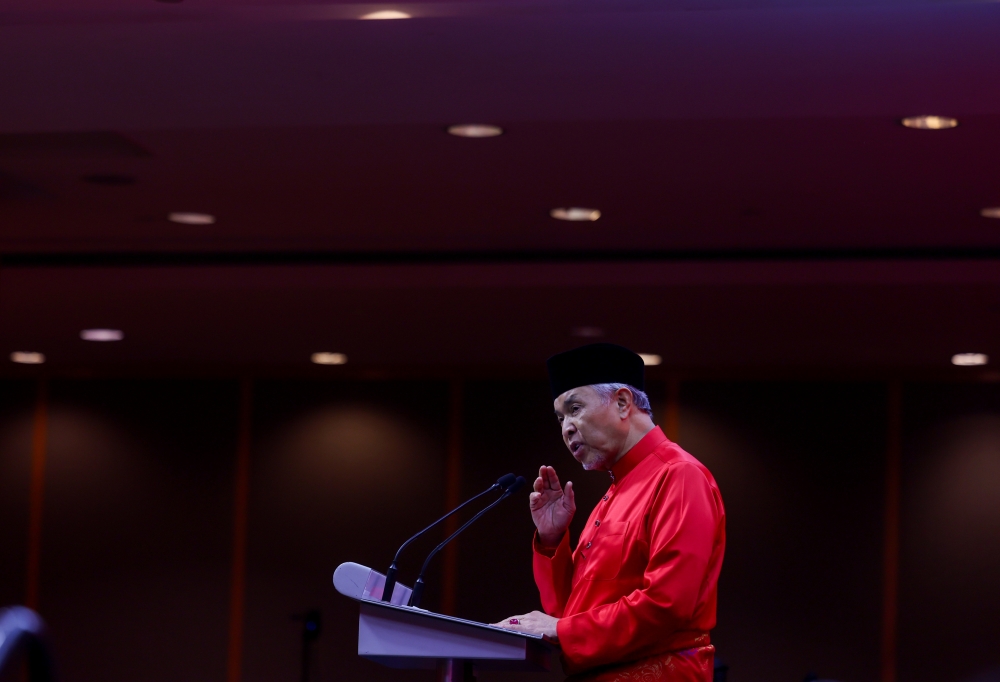 Deputy Prime Minister and UMNO President Datuk Seri Dr Ahmad Zahid Hamidi delivering at the Umno General Assembly 2024 — Bernama pic
