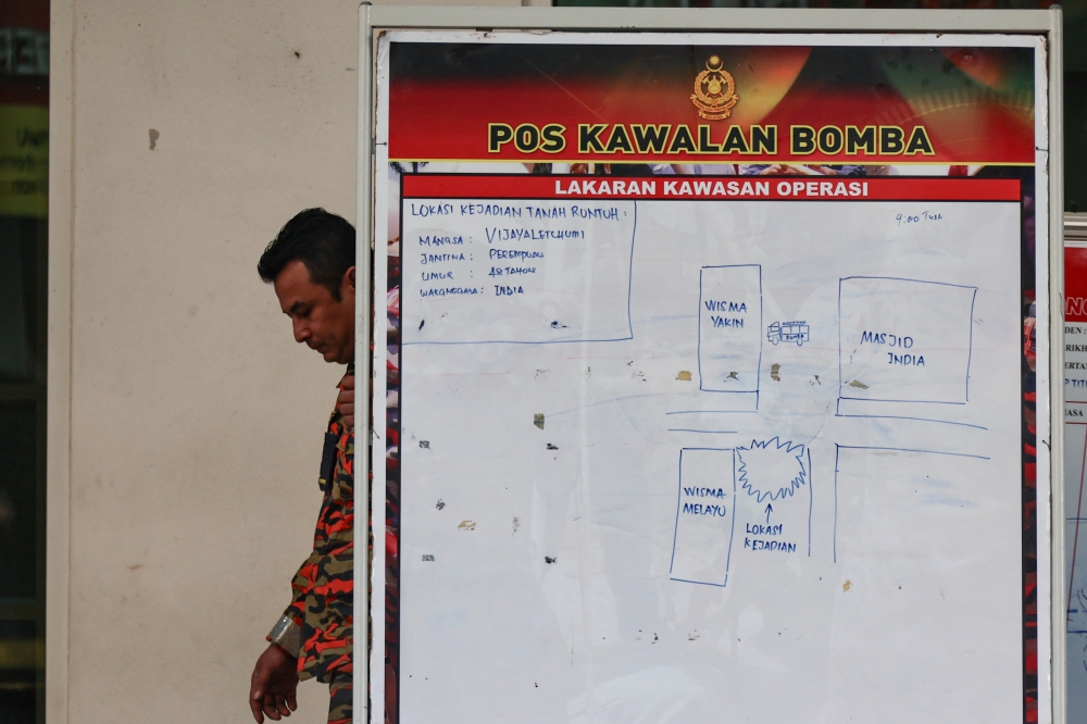 A sketch of the SAR for missing tourist Vijayaletchumy is seen on a white board in Masjid India, where a sinkhole appeared yesterday near the Malayan Mansion flats. — Bernama pic