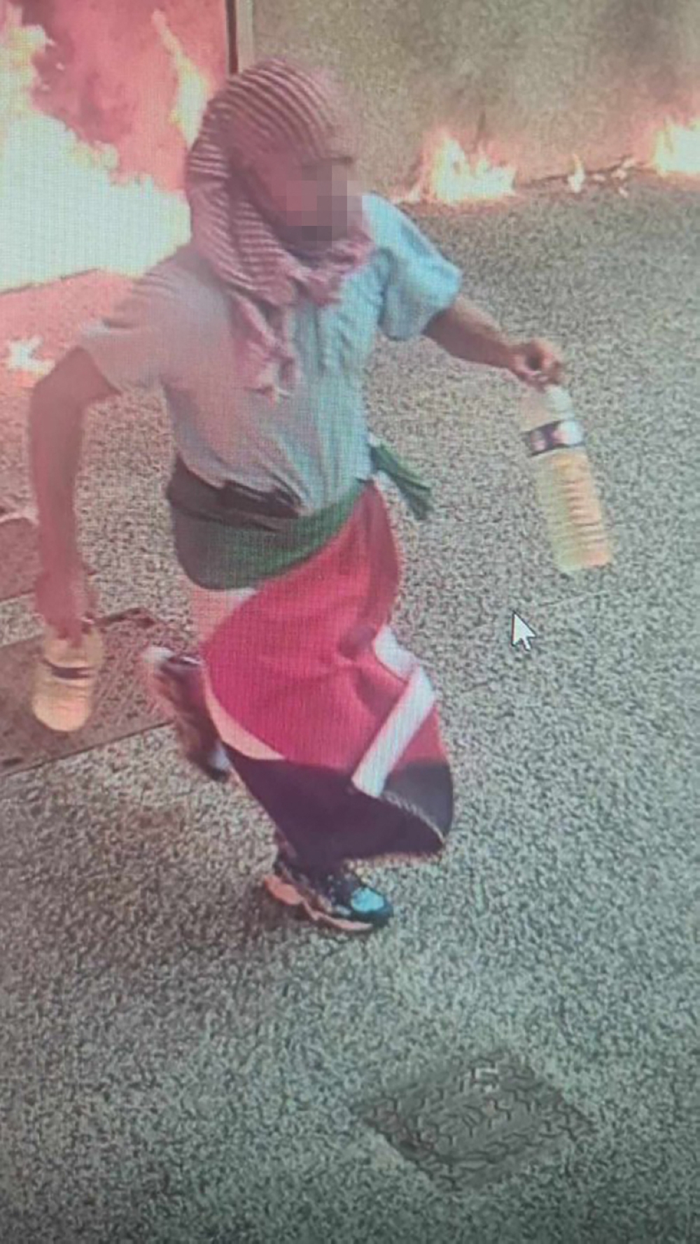 CCTV footage shows a man wearing a keffiyeh with a Palestinian flag draped around his waist leaving the scene where two cars outside a synagogue burst into flames after a gas canister likely exploded, in La Grande-Motte, southern France on August 24, 2024. — AFP pic