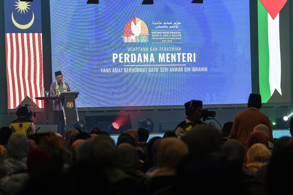 Prime Minister Datuk Seri Anwar Ibrahim delivers a speech at the Malaysia Mosque for Al-Aqsa and Palestine (MM4AP) Conference, in conjunction with the International Day of the Mosque 2024, at the Federal Territory Mosque in Kuala Lumpur August 25, 2024. — Bernama pic