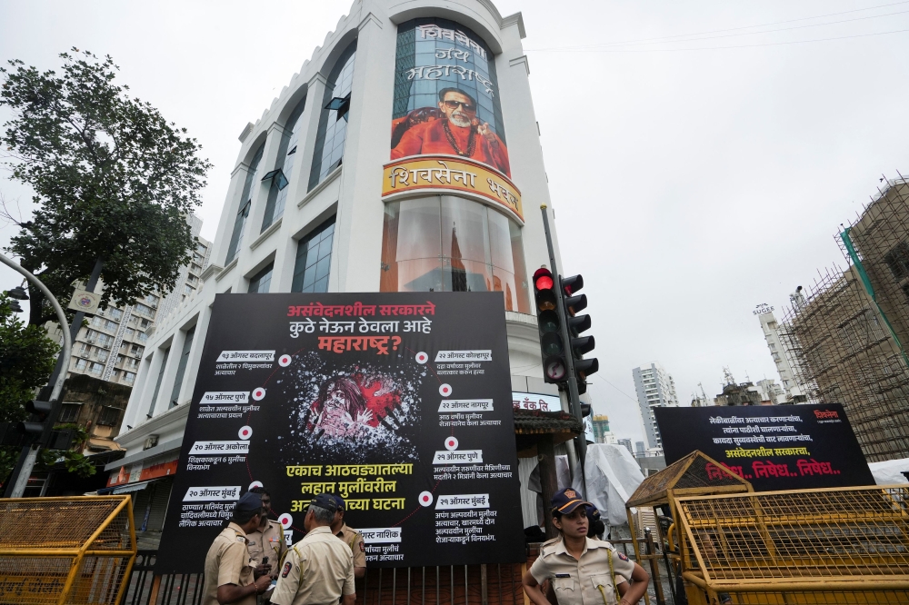 Indian police officers are seen on duty in Mumbai on August 24, 2024. Starting April 1, 2025, over two million federal government staff in India are guaranteed to receive 50 per cent of their base salary as pensions. — Reuters pic