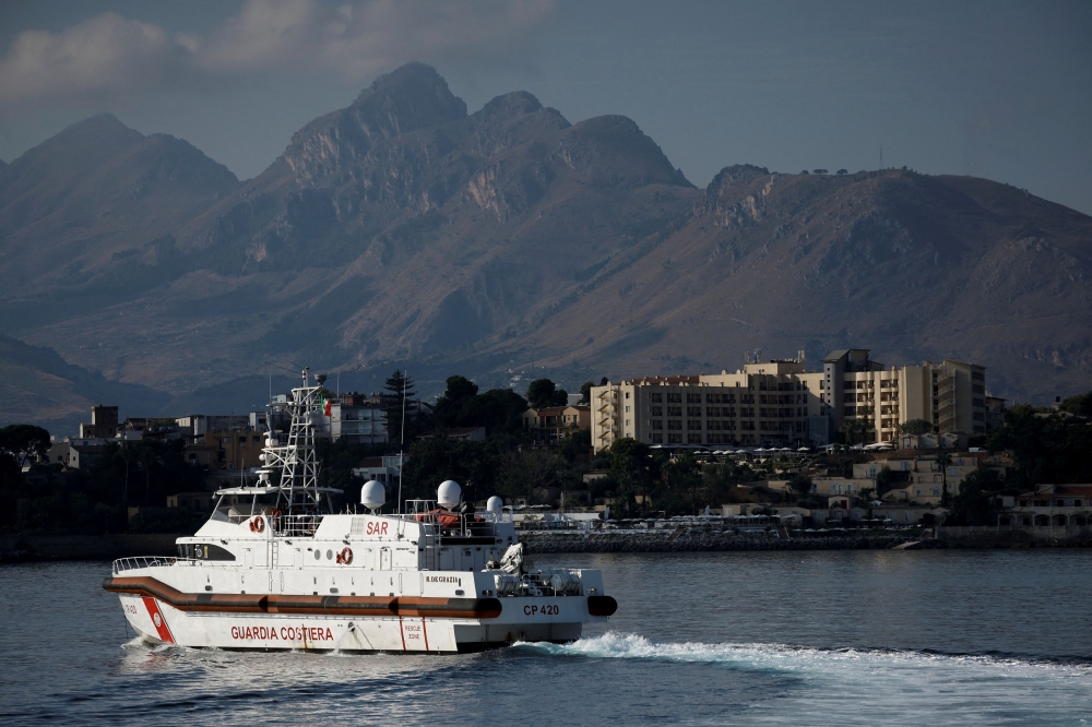 A Coast Guard vessel is pictured in front of the Domina Zagarella Sicily hotel where the survivors are staying after a luxury yacht sank, killing seven. — Reuters pic