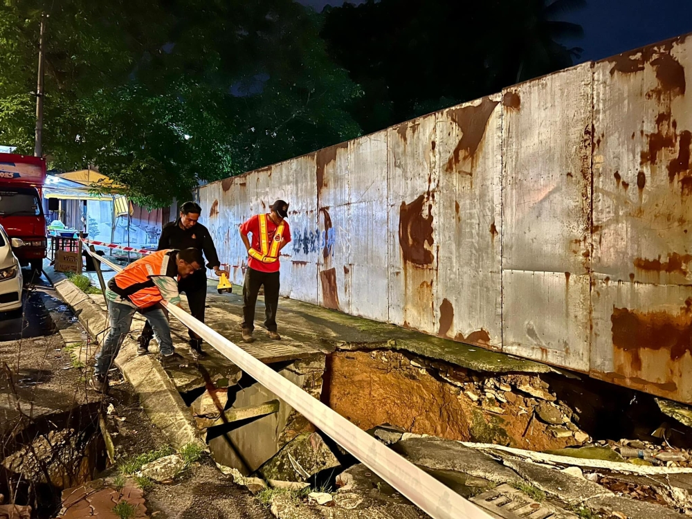A drain had collapsed at Kg Kerinchi, leaving a large sinkhole. — Picture from Facebook/DBKL