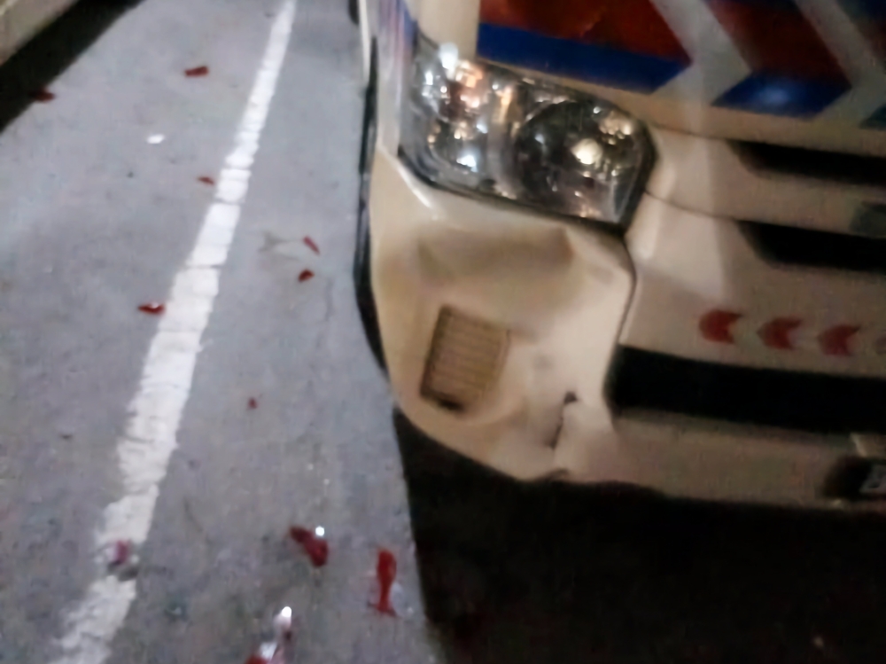 A picture of the ambulance damaged by an attack by men with machetes, intending to harm the occupant being rushed to the hospital. — Picture via social media
