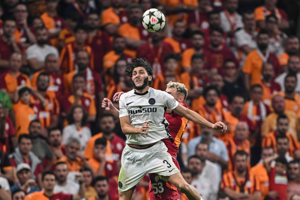 Young Boys’ Algerian defender Jaouen Hadjam (left) and Galatasaray’s Turkish midfielder Barış Alper Yılmaz fight for the ball during the Champions League second leg play off football match between Galatasaray and Young Boys at the Rams Park stadium in Istanbul, on August 27, 2024. — AFP pic 