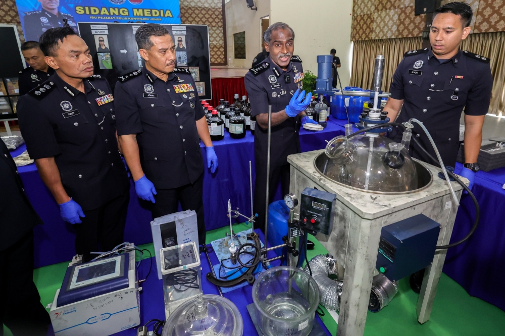 Johor police chief CP M. Kumar (2nd right) shows drug processing equipment seized from several raids during a press conference at the Johor police contingent headquarters August 28, 2024. — Bernama pic