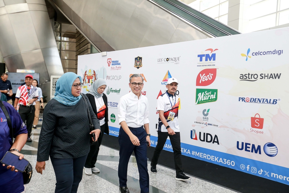 Communication Minister Fahmi Fadzil on the way to brief the media on the upcoming Merdeka celebration in Putrajaya. — Picture by Sayuti Zainudin