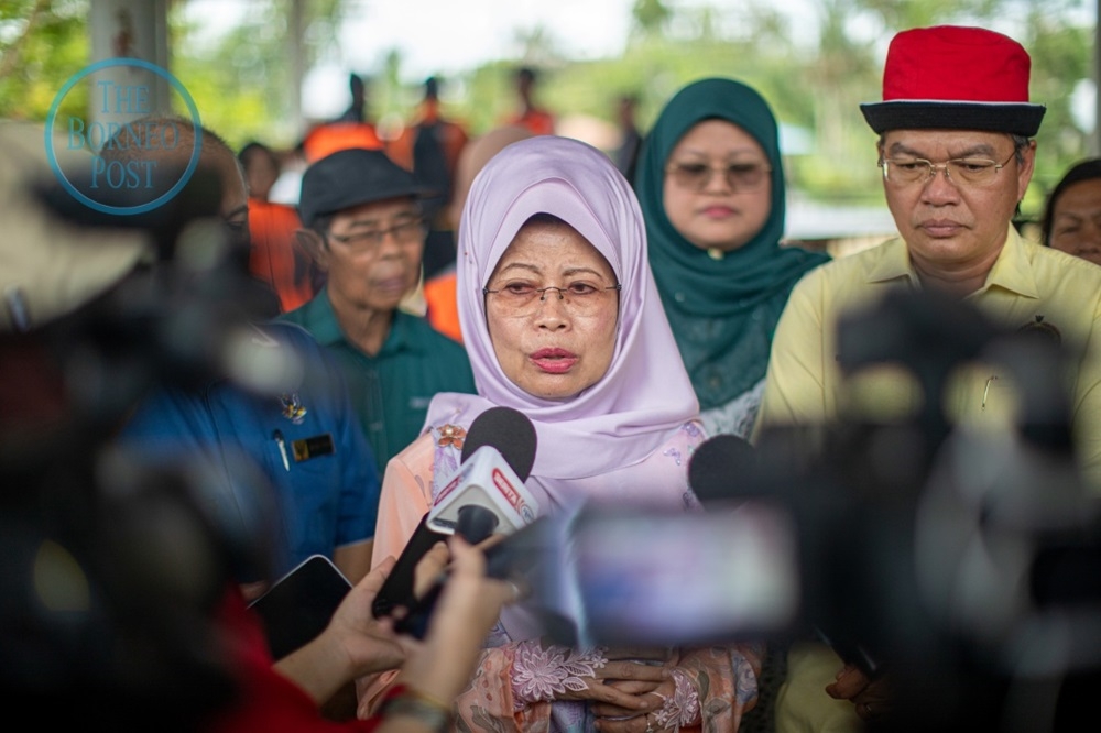 Fatimah speaks to reporters at Dewan Aseng Kampung Bitokan 2 while Billy (right) looks on. — Chimon Upon/The Borneo Post pic 