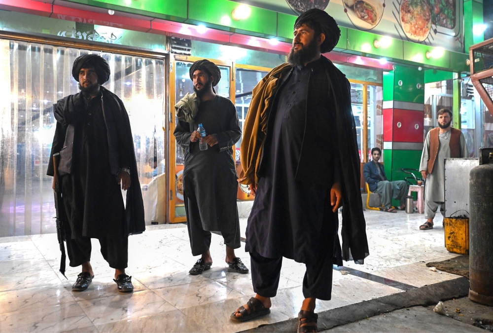 The Taliban's law imposes wide-ranging rules on men’s clothing and attending prayers as well as bans on keeping photos of living beings, homosexuality, animal fighting, playing music in public and non-Muslim holidays. — AFP pic