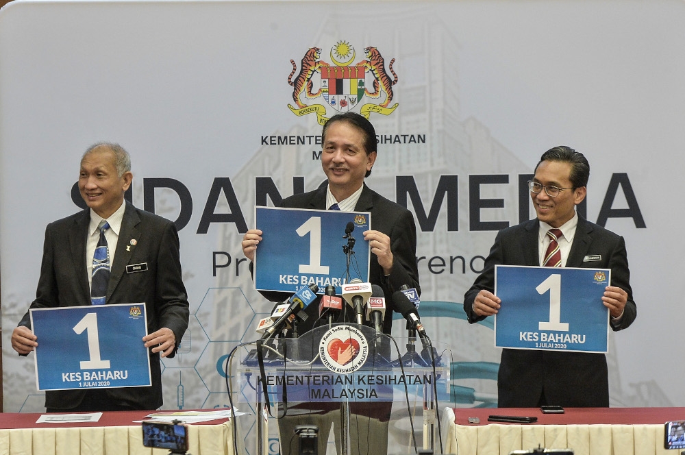 File picture of Health director-general Tan Sri Dr Noor Hisham Abdullah holding a poster showing the number of Covid-19 cases reported on July 1, 2020. — Picture by Shafwan Zaidon