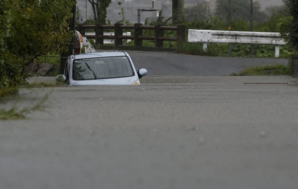A car is submerged at a flooded area due to heavy rains from Typhoon Shanshan in Yufu, Oita Prefecture, south-western Japan, August 29, 2024, in this photo taken by Kyodo. — Kyodo pic via Reuters 