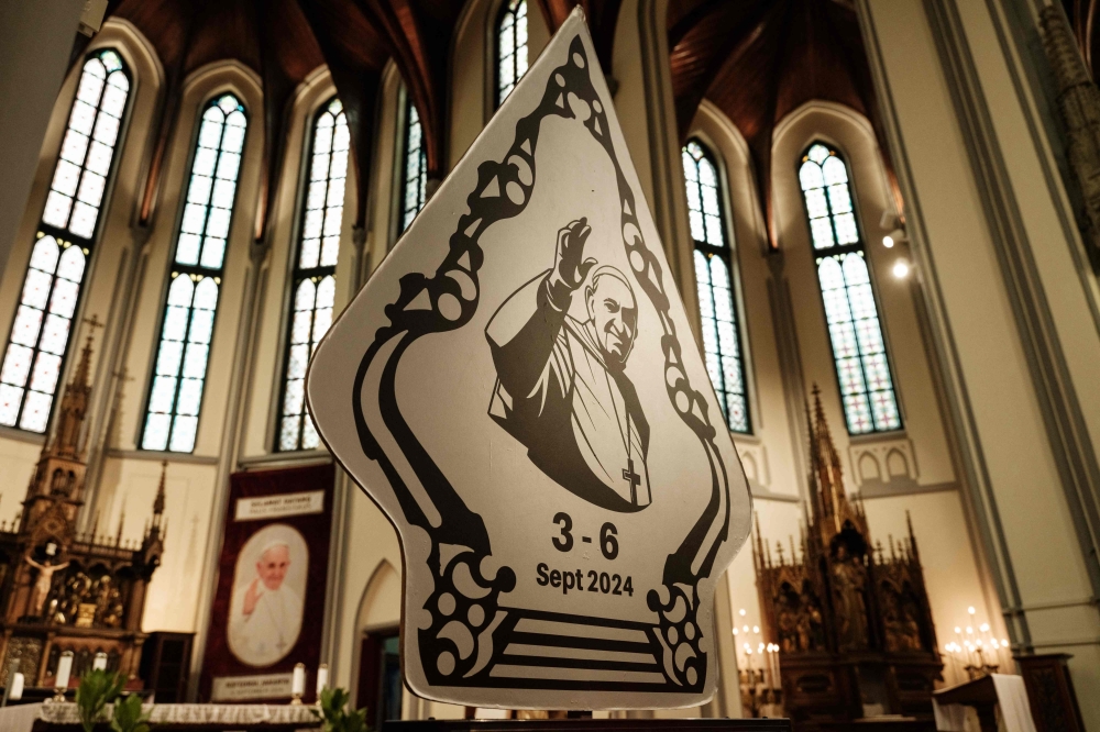 A welcoming signboard for Pope Francis is displayed at the Jakarta Cathedral in Jakarta on August 30, 2024. — AFP pic