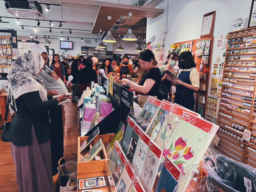 Excited Malaysian shoppers looking through available Hobonichi Techo stock. — Picture by Erna Mahyuni