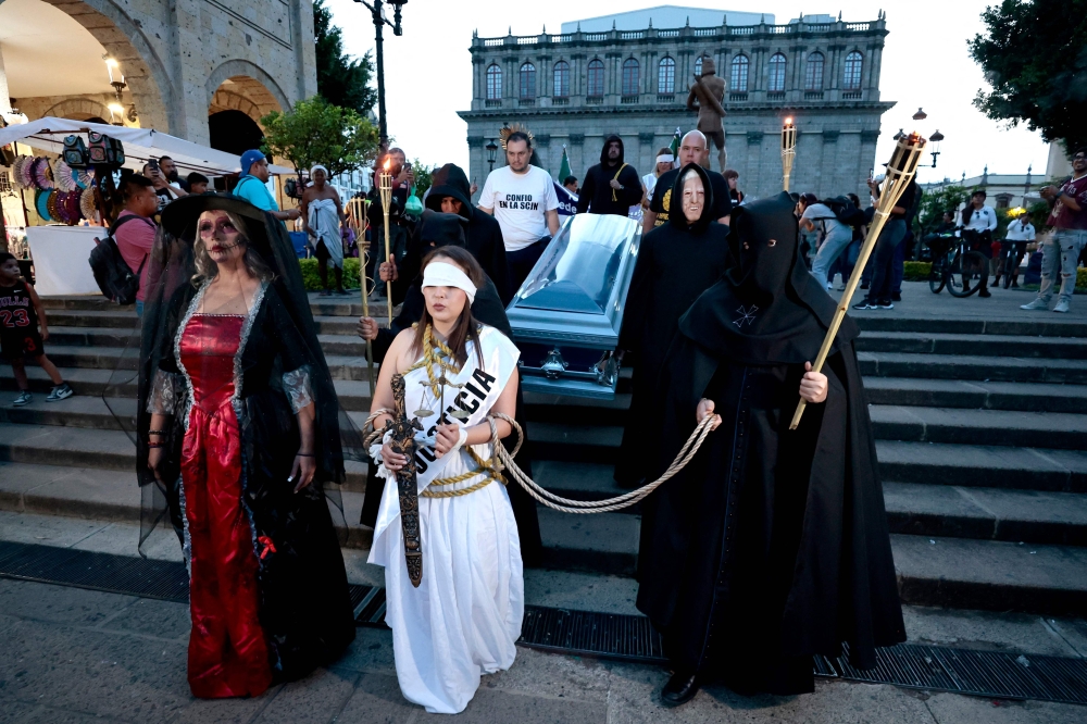 A Judicial Branch employee dressed as Themis staged a performance as she took part in a protest against the judicial reform proposed by the government in Guadalajara, Jalisco State, Mexico on August 26, 2024. — AFP pic
