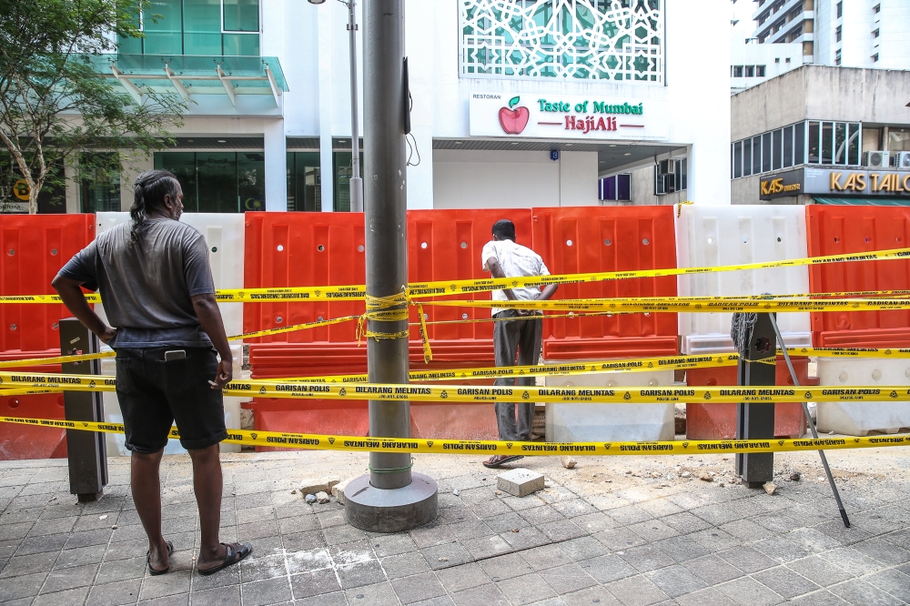 The public has been advised to stay away from the Jalan Masjid India sinkhole for their safety. — Picture by Yusof Mat Isa