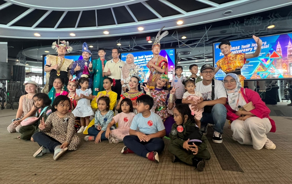 A group photo taken during one of the activities run in connection with the Petronas Twin Towers’ 25th anniversary celebration in Kuala Lumpur. — The Borneo Post pic 