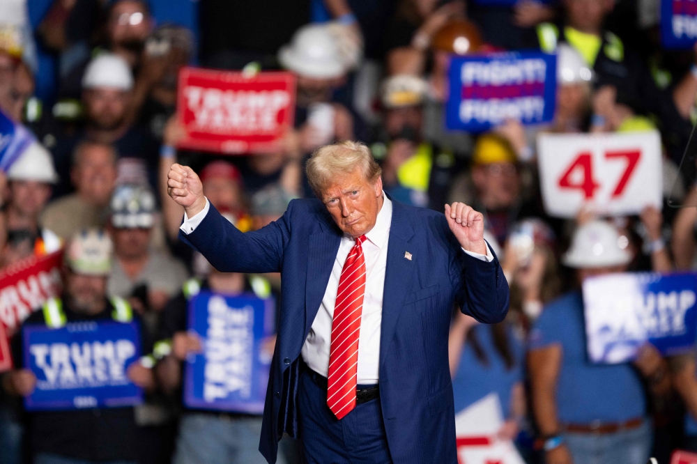 Former US President and Republican presidential candidate Donald Trump dances to a song as he leaves a rally at 1st Summit Arena at the Cambria County War Memorial in Johnstown, Pennsylvania, on August 30, 2024. — AFP pic