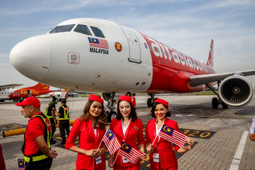 Cabin crew of AirAsia pose during AirAsia celebrates inaugural flights at Sultan Abdul Aziz Shah Airport, Subang, Selangor August 30, 2024. — Picture by Firdaus Latif