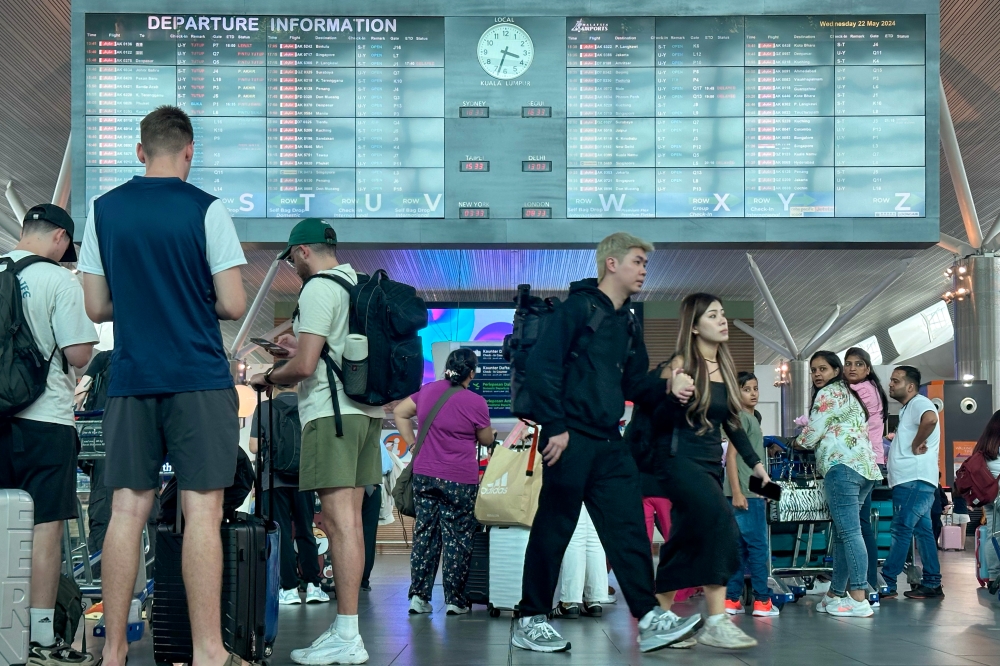 Travellers are seen at the Kuala Lumpur International Airport 2 in Sepang, Selangor in this file picture dated May 22, 2024. — Picture by Shafwan Zaidon