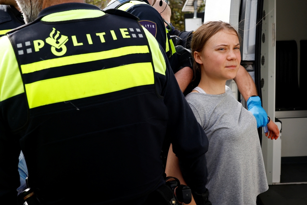 Activist Greta Thunberg detained by police during a protest in The Hague April 6, 2024. — Reuters pic