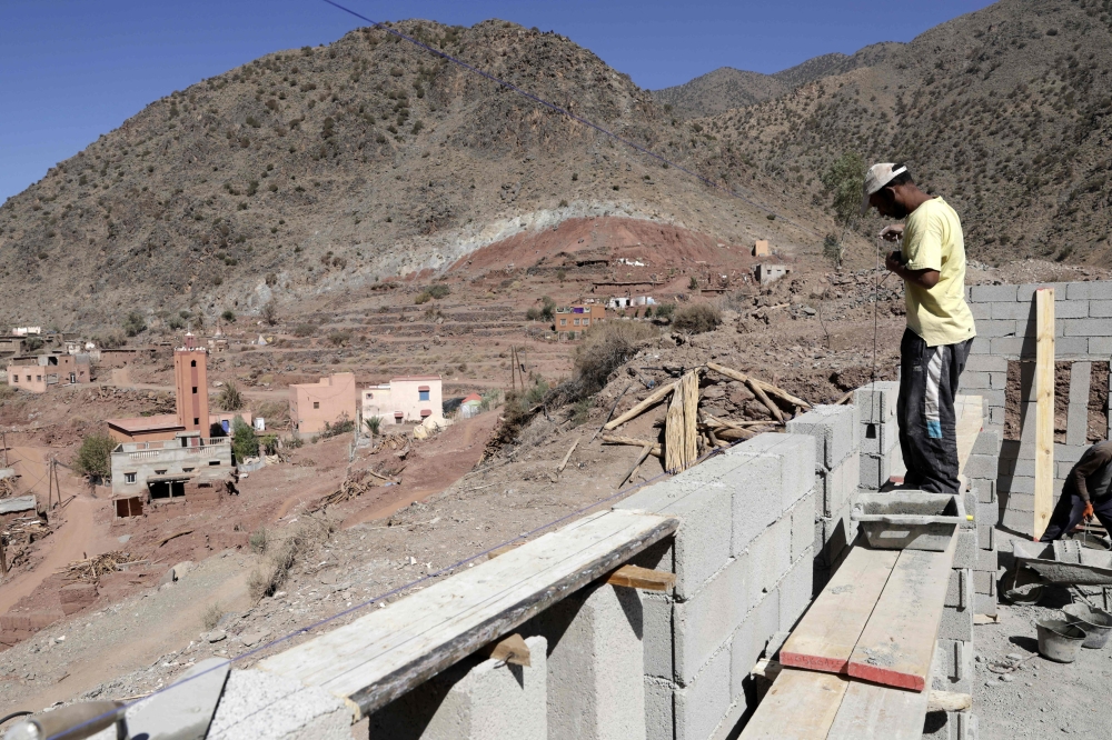 Workers construct a new house in Douar Tiniskt, in the el-Haouz province in the High Atlas Mountains south of Marrakesh, on August 27, 2024, almost a year after a devastating 6.8-magnitude earthquake struck the country. — AFP pic 