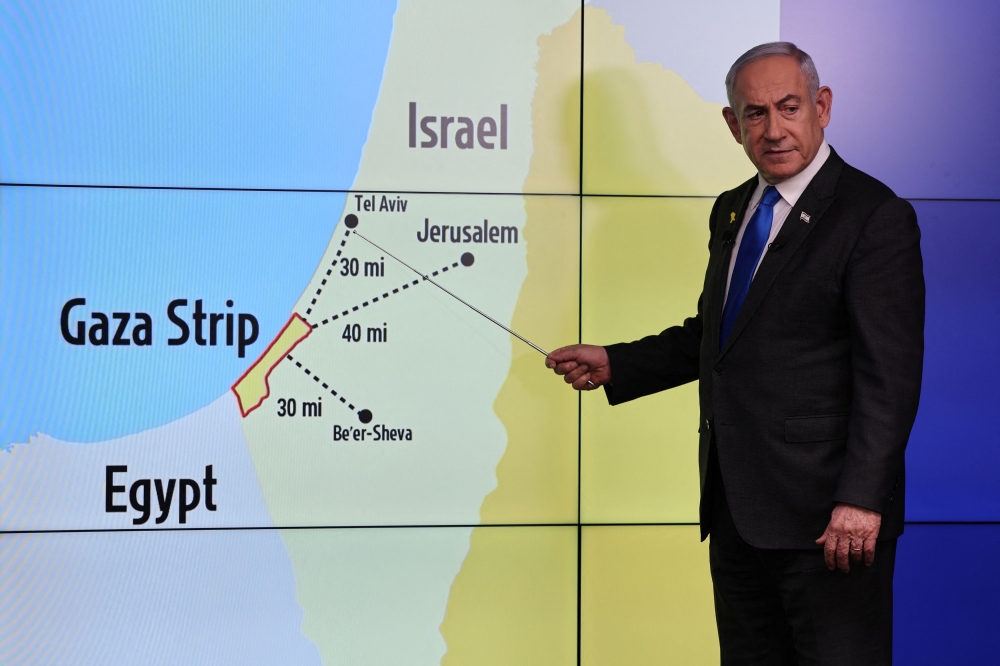 Israeli Prime Minister Benjamin Netanyahu stands before a map showing the Gaza Strip, during a press conference for the international media at the Government Press office in Jerusalem, amid the Israel-Hamas conflict, 04 September 2024. — Reuters pic