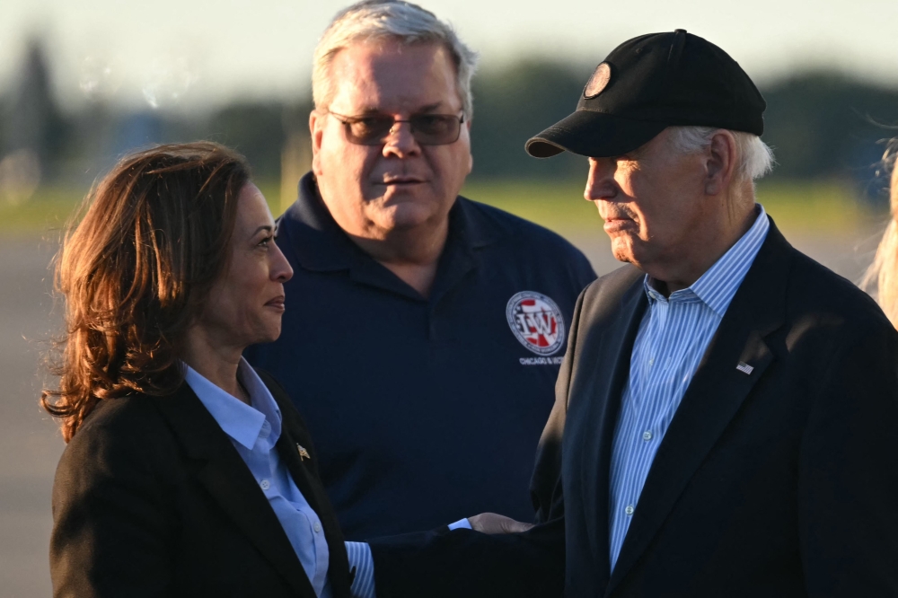 US Vice President and Democratic presidential candidate Kamala Harris (left) speaks to US President Joe Biden before boarding Air Force Two to departing Pittsburgh International Airport in Pittsburgh, Pennsylvania, on September 2, 2024. — AFP pic