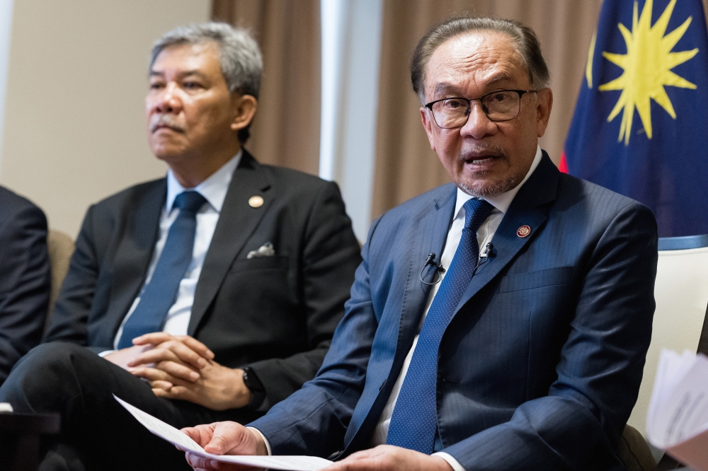 Prime Minister Datuk Seri Anwar Ibrahim (right) speaks during a press conference during a two-day working visit in conjunction with the 9th Eastern Economic Forum at Far Eastern Federal University campus in Valdivostok September 5, 2024. — Bernama pic