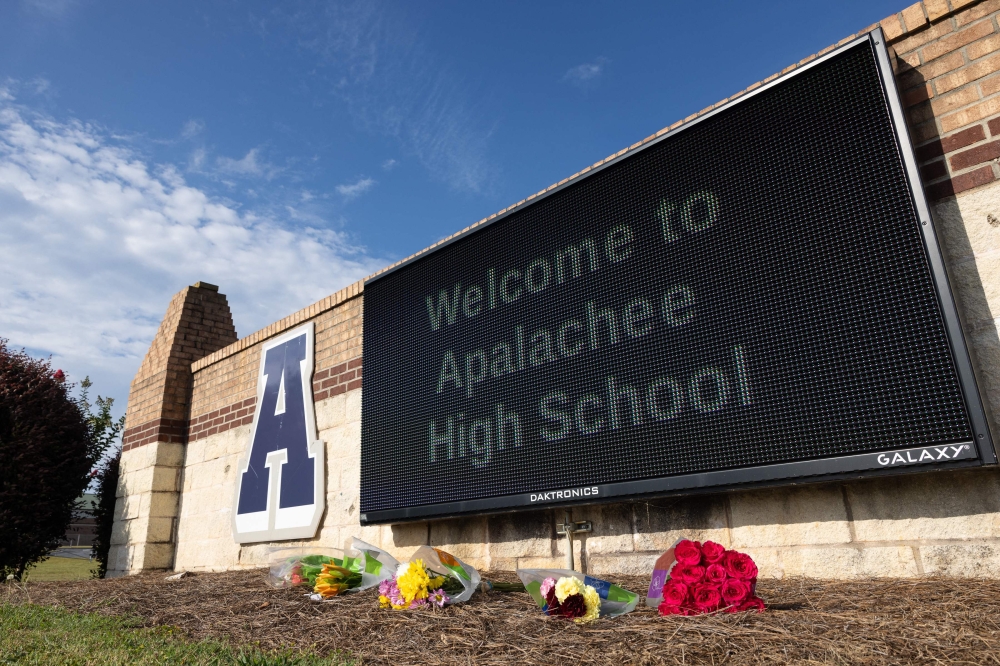 Flower tributes lie in front of the Apalachee High School Georgia, the US where two students and two teachers were shot dead by a 14-year-old on September 4, 2024. — AFP pic