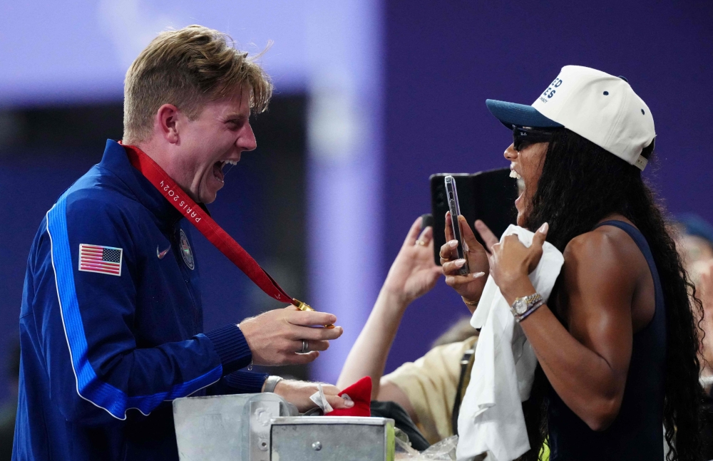Gold medallist US’ Hunter Woodhall (left) celebrates with his wife Olympic women’s long jump champion Tara Davis-Woodhall after the victory ceremony for the Men’s 400m T62 final event at the Stade de France in Saint-Denis, outside Paris on September 6, 2024. — AFP pic