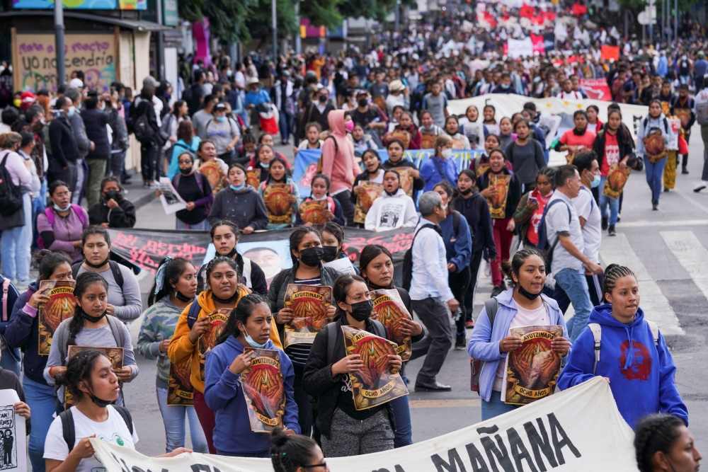 People march to mark the 8th anniversary since the disappearance of the 43 students of the Ayotzinapa College 