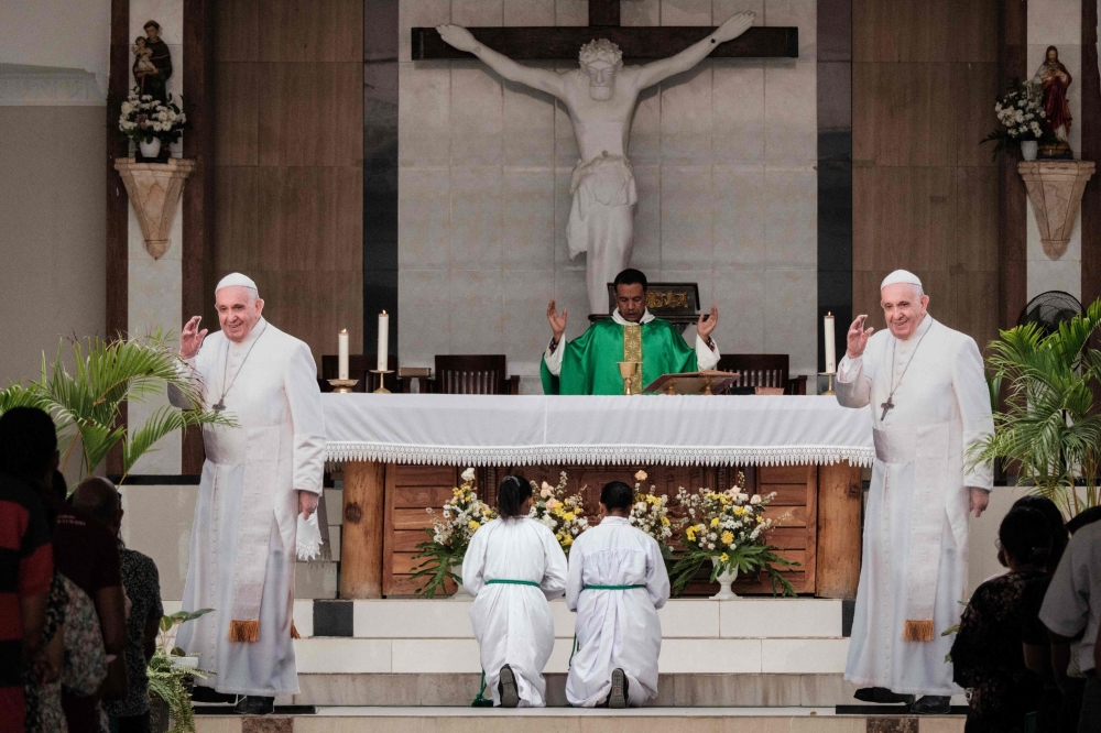 Two life-size boards of Pope Francis are displayed during Sunday Mass at the Church of Saint Anthony of Motael in Dili, East Timor ahead of Pope Francis’ visit on September 8, 2024. — AFP pic