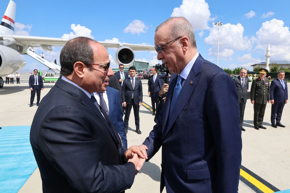 Turkish President Recep Tayyip Erdogan (right) welcomes Egyptian counterpart Abdel Fattah al-Sisi at the tarmac in Ankara, Turkiye  on September 4, 2024. — AFP pic