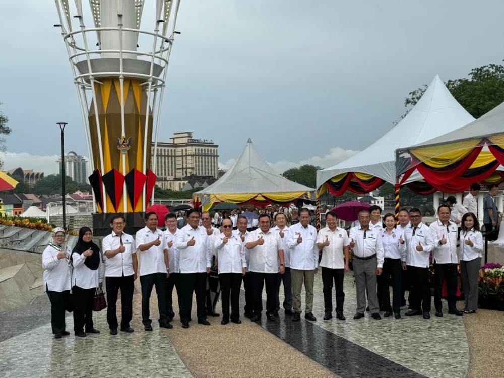 Abdul Rahman (6th left) and Uggah on his left in a group photo with other guests at the flag-raising ceremony today. — The Borneo Post pic