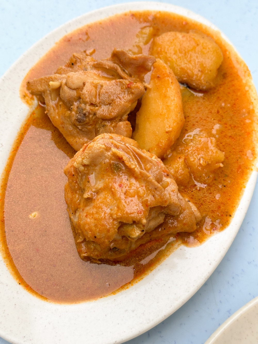 Chicken curry is also offered here but the curry lacks depth even though the chicken is served in large, juicy pieces — Picture by Lee Khang Yi