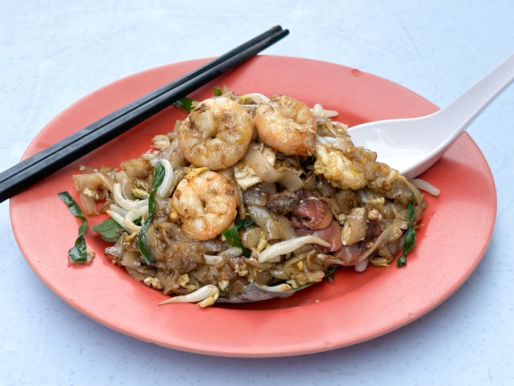 The ‘char kway teow’ here is incredibly satisfying with prawns, juicy cockles and charred flat rice noodles — Picture by Lee Khang Yi