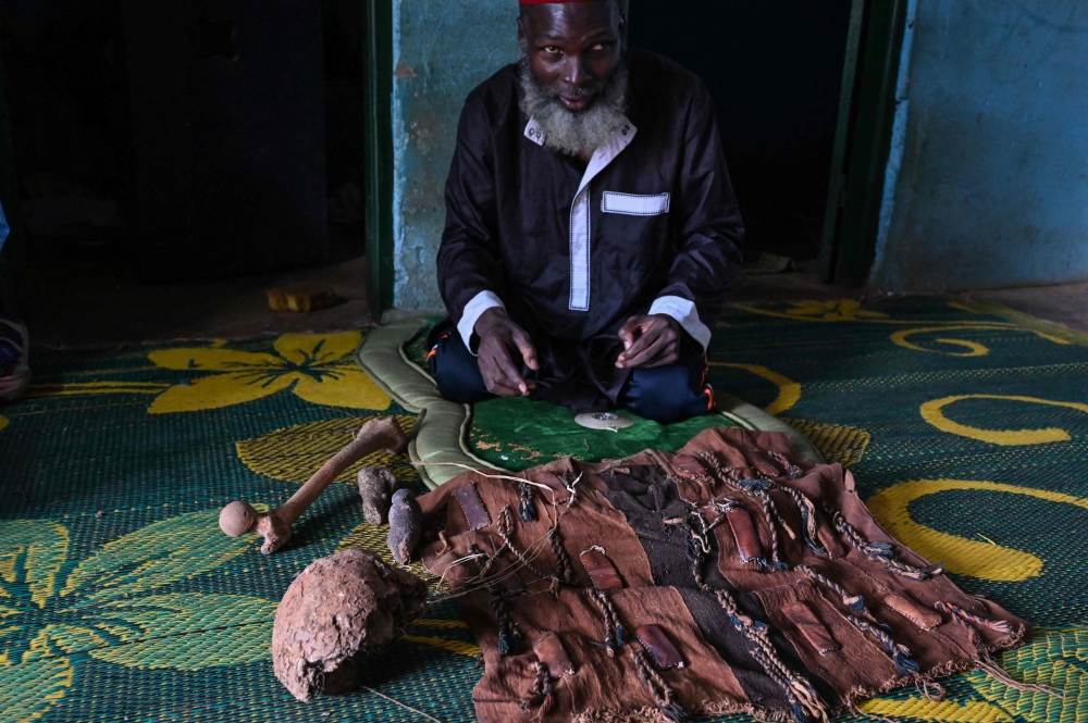 Mory Bamba, a Muslim religious leader who fights against the excision of girls, looks at a fetish used by former circumcisers in his village near Touba, Ivory Coast, on July 10, 2024. — AFP pic