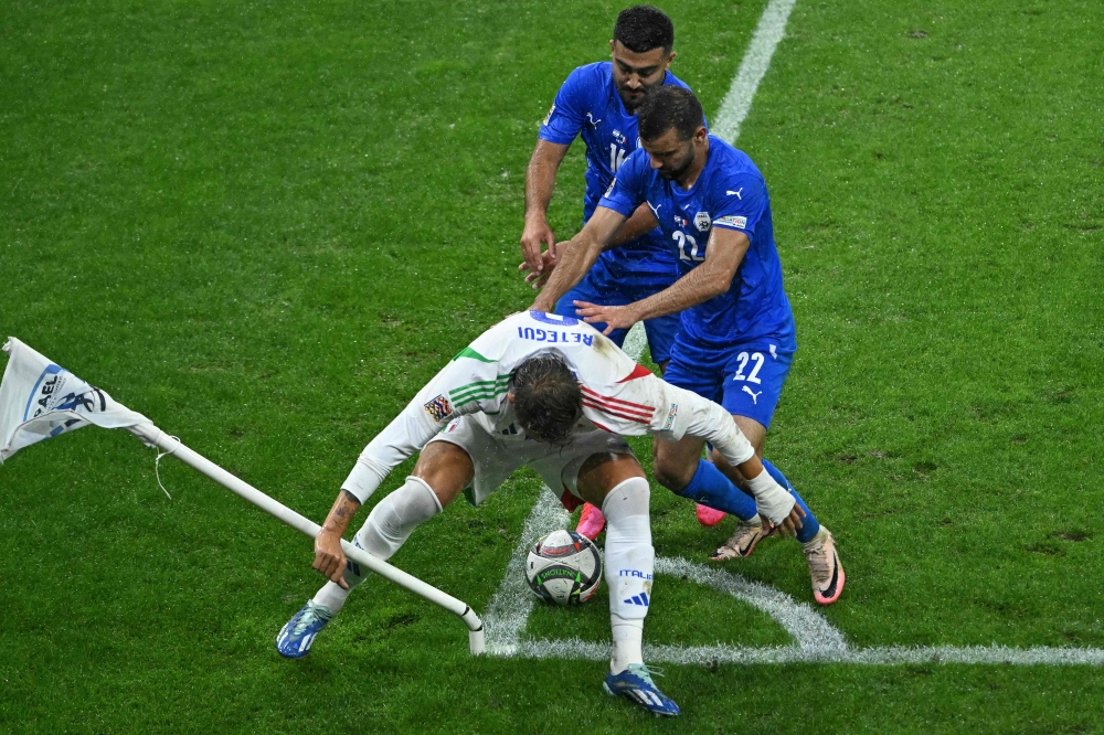 Italy's forward Mateo Retegui attempts to keep the ball from Israel's players at the corner flag to see out the final minutes of the match during the Uefa Nations League, League A, Group A2 football match Israel vs Italy at the Bozsik Arena in Budapest, Hungary, on September 9, 2024. — AFP pic