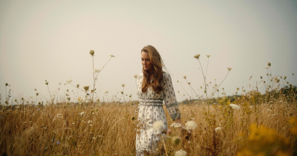 A handout still released yesterday, taken in Norfolk on an unspecified date last month shows Britain's Catherine, Princess of Wales, walking in a field. — Picture from AFP