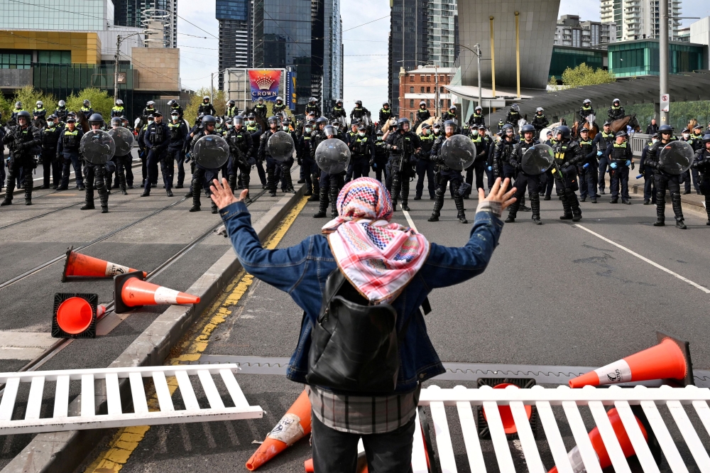 A protester stands during a rally against the Land Forces International Land Defence Exposition at the Melbourne Convention and Exhibition Centre in Melbourne, Australia, September 11, 2024. — Reuters pic