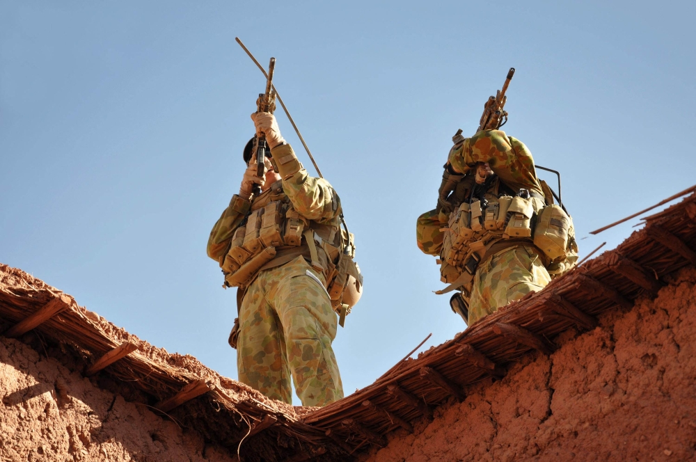 A handout photo released by Australian Department of Defence on October 21, 2009 shows Australian soldiers from the Special Operations Task Group using their rifle scopes to investigate the surrounding mountains during an operation in southern Afghanistan. — AFP pic