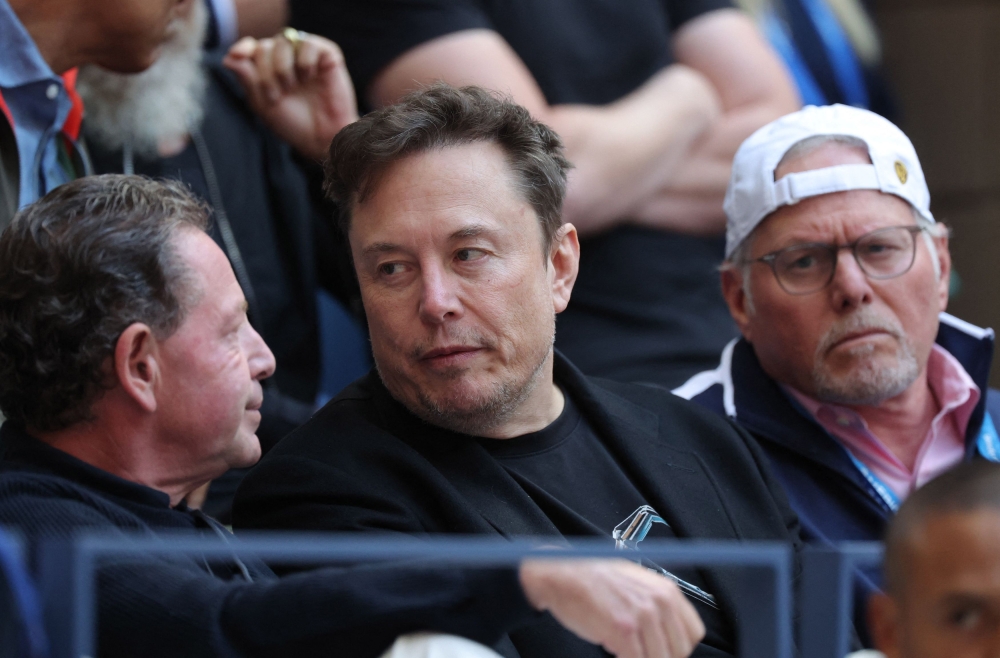 Billionaire Elon Musk (centre) did not take kindly to Australian laws that would make tech giants responsible for misinformation. — Reuters pic